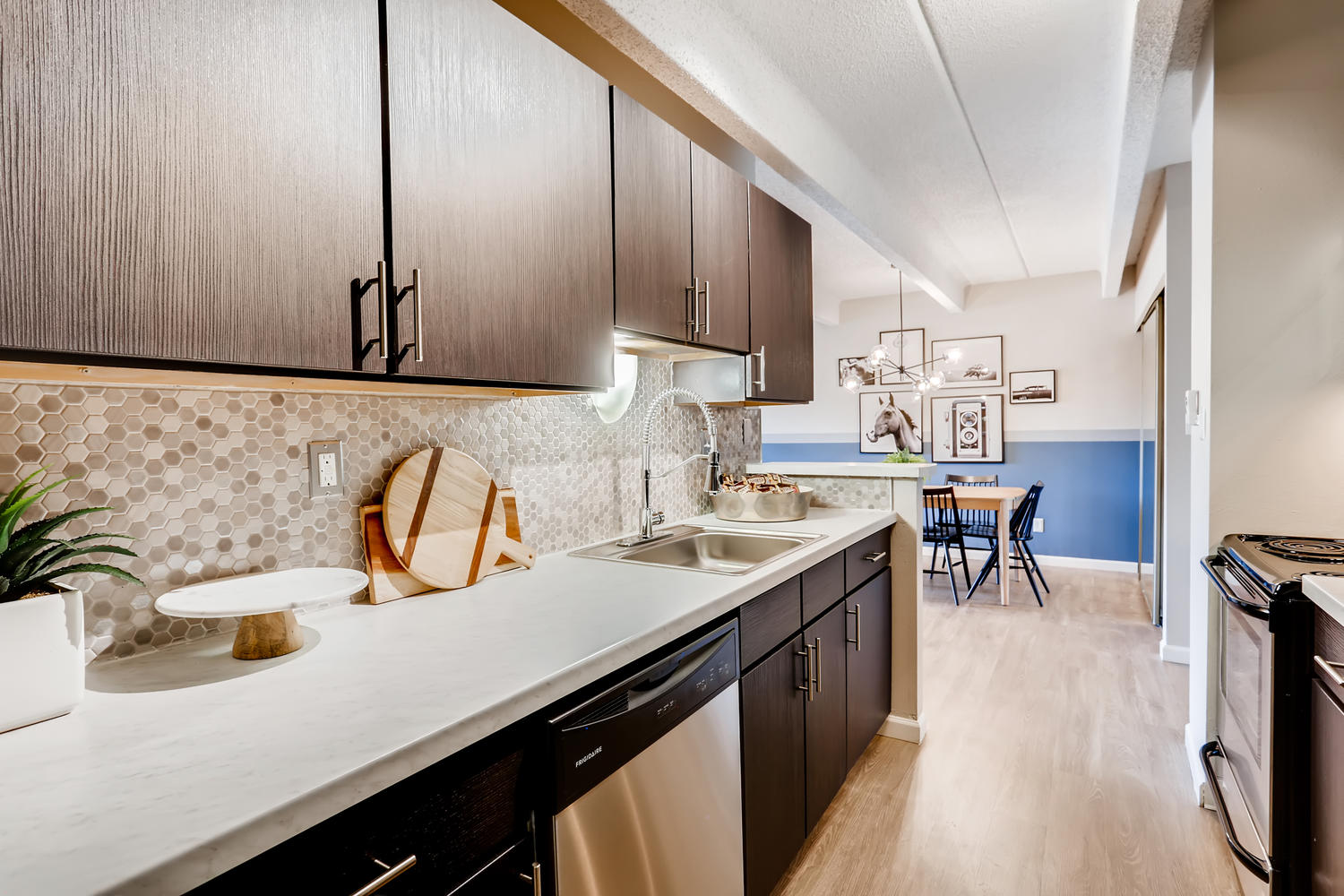 open kitchen with neutral color back splace and semi view of dining area