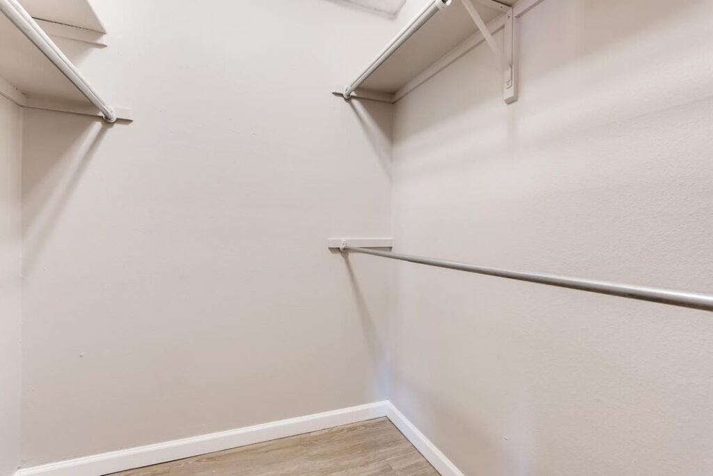 large walk in closet with shelves