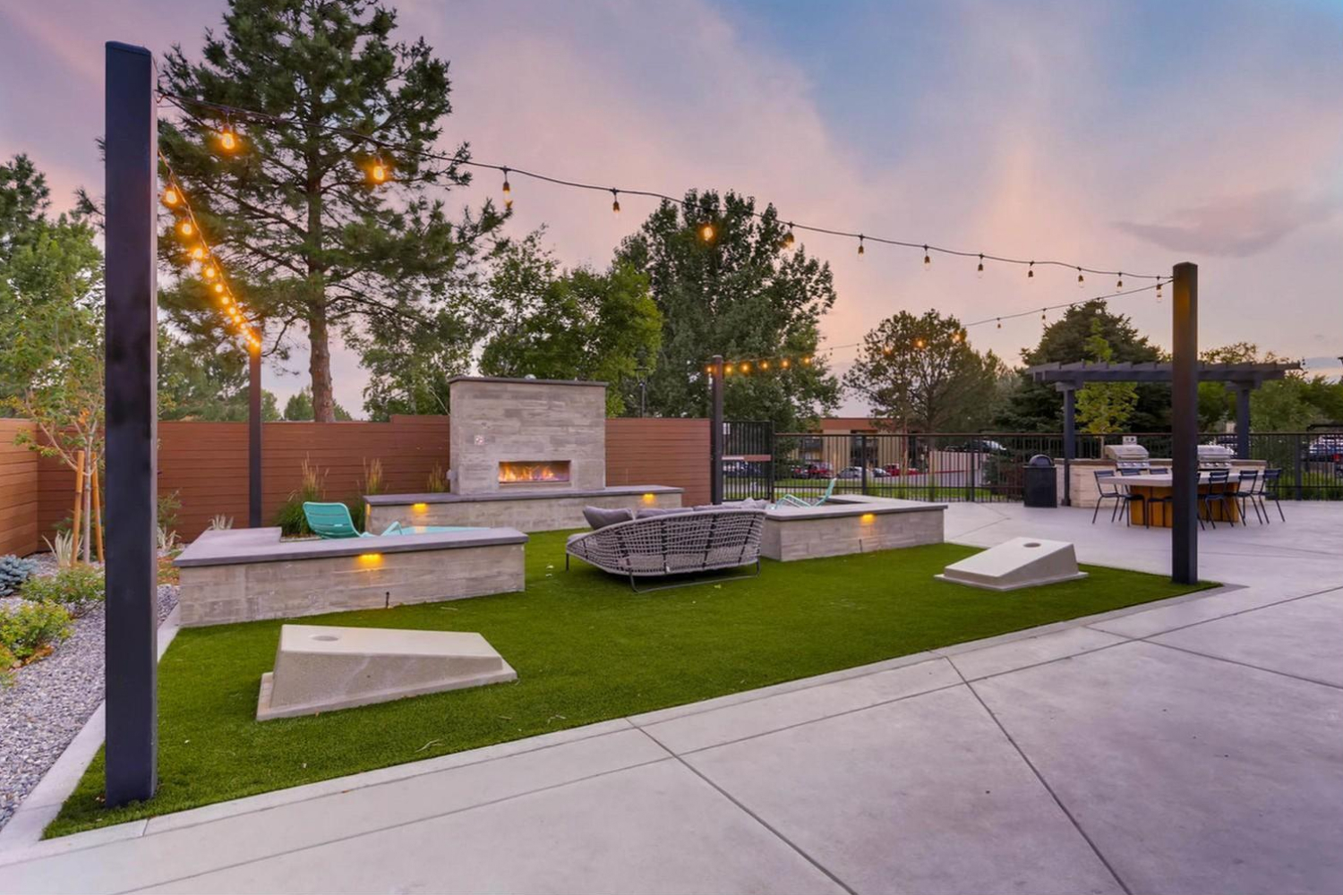 outside seating area with tiki lights and fireplace