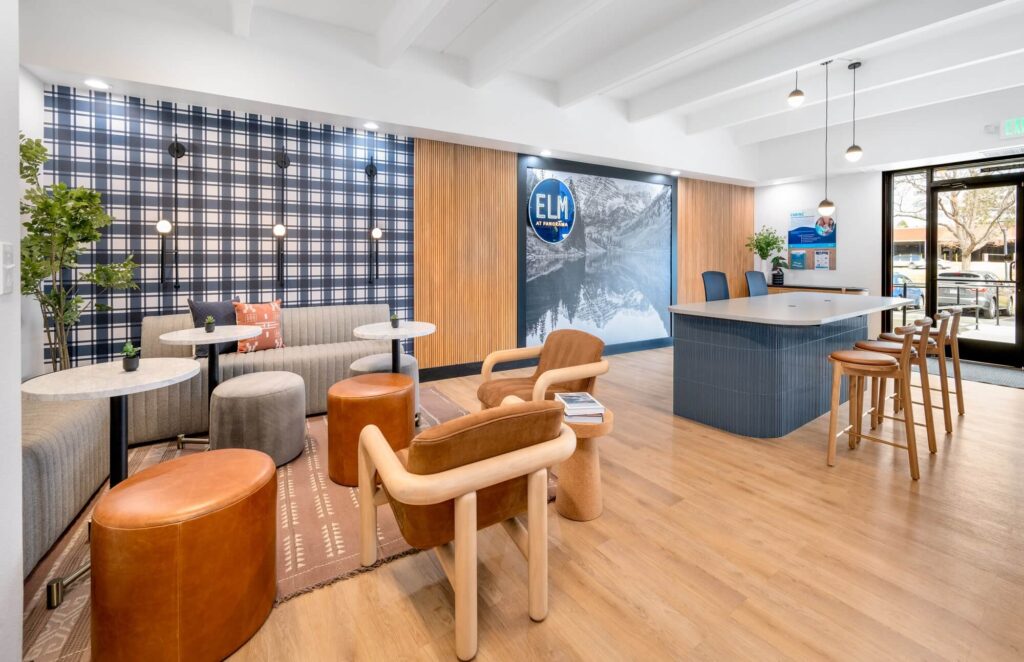 reception space with bar height counter and bar stool seating next to seating lounge space